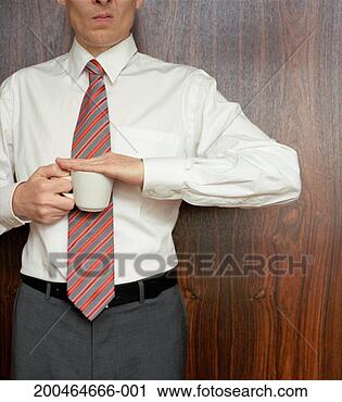 Stock Photography - business man holding 
hand over coffee 
cup, mid section. 
fotosearch - search 
stock photos, 
pictures, images, 
and photo clipart