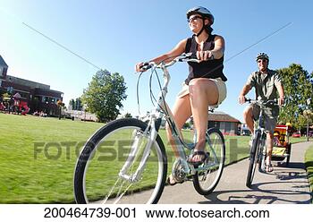 Stock Photography - family cycling, 
low angle view, 
(blurred motion). 
fotosearch - search 
stock photos, 
pictures, images, 
and photo clipart