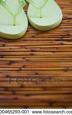 Stock Photography - flip-flops on 
bamboo mat, close-up. 
fotosearch - search 
stock photos, 
pictures, images, 
and photo clipart