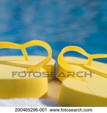 Stock Photography - flip-flops on 
towel by pool, 
close-up. fotosearch 
- search stock 
photos, pictures, 
images, and photo 
clipart