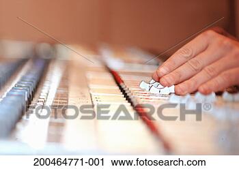 Stock Photography - hand adjusting 
faders on audio 
mixing board, 
(focus on hand). 
fotosearch - search 
stock photos, 
pictures, images, 
and photo clipart