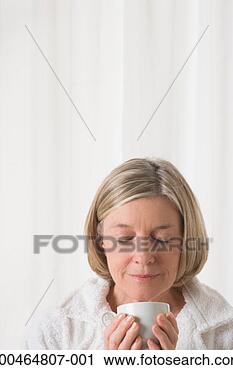 Stock Photography - mature woman holding 
mug smelling, 
close-up. fotosearch 
- search stock 
photos, pictures, 
images, and photo 
clipart
