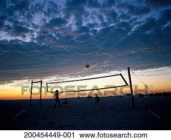 Stock Photography - people playing 
volleyball on 
beach, dusk, (blurred 
motion). fotosearch 
- search stock 
photos, pictures, 
images, and photo 
clipart