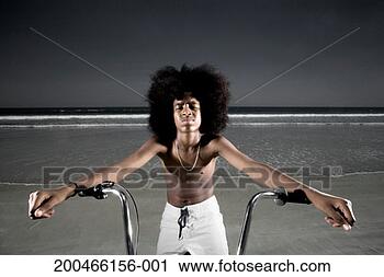 Stock Photography - teenager (13-15) 
sitting on bicycle 
by beach, portrait. 
fotosearch - search 
stock photos, 
pictures, images, 
and photo clipart