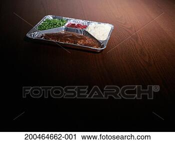 Stock Photography - tv dinner on dark 
wood surface, 
elevated view, 
close-up. fotosearch 
- search stock 
photos, pictures, 
images, and photo 
clipart