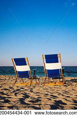 Stock Photography - two deckchairs 
on beach, rear 
view. fotosearch 
- search stock 
photos, pictures, 
images, and photo 
clipart