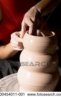 Stock Photography - woman making vase 
on pottery wheel, 
close-up. fotosearch 
- search stock 
photos, pictures, 
images, and photo 
clipart