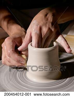Stock Photography - woman making vase 
on pottery wheel, 
close-up. fotosearch 
- search stock 
photos, pictures, 
images, and photo 
clipart