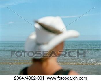 Stock Photography - woman wearing 
white hat, rear 
view, differential 
focus. fotosearch 
- search stock 
photos, pictures, 
images, and photo 
clipart