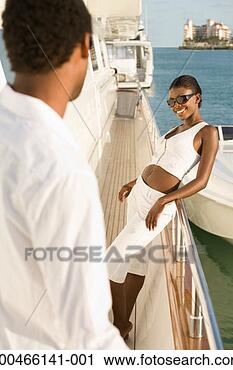 Stock Photography - young couple standing 
on yacht, outdoors. 
fotosearch - search 
stock photos, 
pictures, images, 
and photo clipart