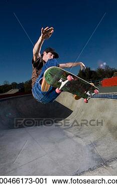 Stock Photography - young man performing 
trick on skateboard, 
close-up. fotosearch 
- search stock 
photos, pictures, 
images, and photo 
clipart