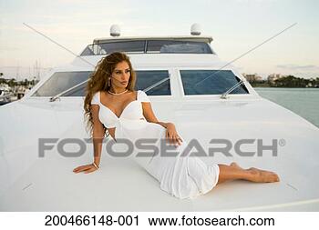 Stock Photography - young woman lying 
on yacht, outdoors. 
fotosearch - search 
stock photos, 
pictures, images, 
and photo clipart