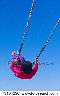 Stock Photography - girl swinging 
on swing, rear 
view, low angle 
view. fotosearch 
- search stock 
photos, pictures, 
images, and photo 
clipart