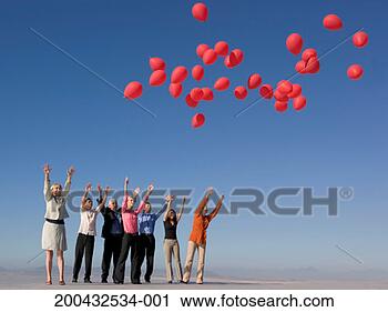 Stock Photography - group of business 
people releasing 
red balloons on 
roof. fotosearch 
- search stock 
photos, pictures, 
images, and photo 
clipart