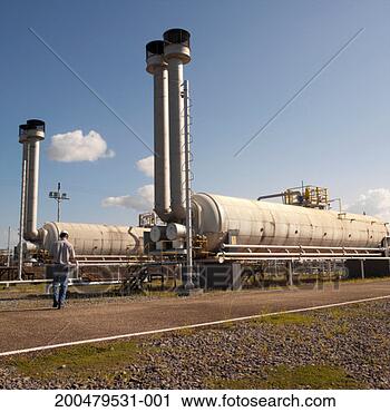 Stock Photography - man walking towards 
machinery, rear 
view. fotosearch 
- search stock 
photos, pictures, 
images, and photo 
clipart