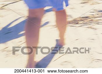 Stock Photography - mature woman walking 
on beach, close-up, 
low section (defocused). 
fotosearch - search 
stock photos, 
pictures, images, 
and photo clipart