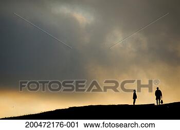 Stock Photography - silhouettes of 
two people standing 
on horizon, dusk. 
fotosearch - search 
stock photos, 
pictures, images, 
and photo clipart