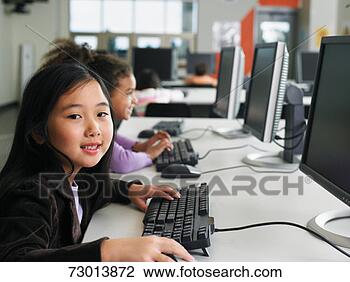 Stock Photo - students (6-9) 
using computers 
in school computer 
lab,  focus on 
girl. fotosearch 
- search stock 
photos, pictures, 
images, and photo 
clipart