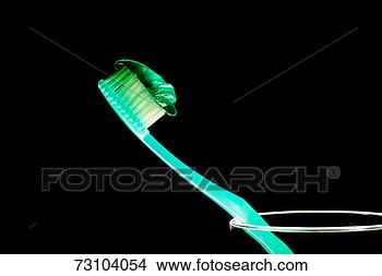 Stock Photo - toothpaste on 
toothbrush in 
plastic glass, 
close-up. fotosearch 
- search stock 
photos, pictures, 
images, and photo 
clipart