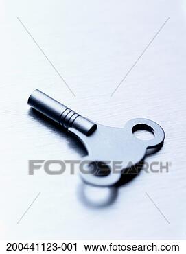 Stock Photography - wind-up key on 
metal surface, 
close-up. fotosearch 
- search stock 
photos, pictures, 
images, and photo 
clipart