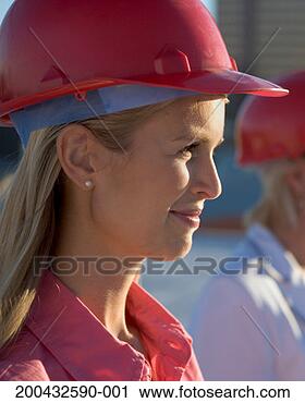 Stock Photography - young business 
woman wearing 
hard hat, side 
view. fotosearch 
- search stock 
photos, pictures, 
images, and photo 
clipart