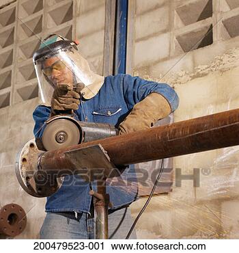 Stock Photography - young man using 
angle grinder 
on pipe, low angle 
view. fotosearch 
- search stock 
photos, pictures, 
images, and photo 
clipart