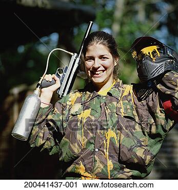 Stock Photography - young woman holding 
paintball gun 
and helmet, smiling, 
portrait. fotosearch 
- search stock 
photos, pictures, 
images, and photo 
clipart