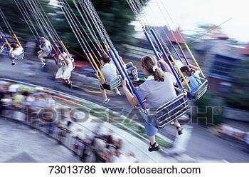 Stock Photo - group of people 
swimming on swing 
in amusement park 
(blurred motion). 
fotosearch - search 
stock photos, 
pictures, images, 
and photo clipart