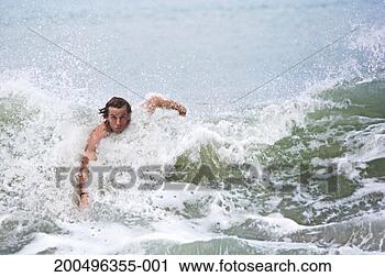 Stock Photography - man swimming in 
waves in sea, 
portrait, close-up. 
fotosearch - search 
stock photos, 
pictures, images, 
and photo clipart
