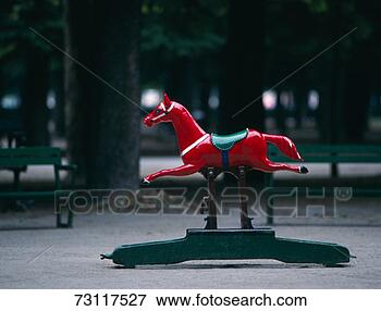 Picture - rocking horse 
ride in park. 
fotosearch - search 
stock photos, 
pictures, images, 
and photo clipart