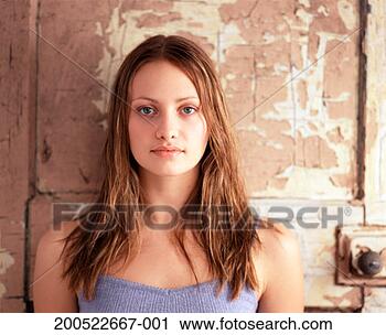 Stock Photography - young woman, with 
old door in background, 
close-up, portrait. 
fotosearch - search 
stock photos, 
pictures, images, 
and photo clipart