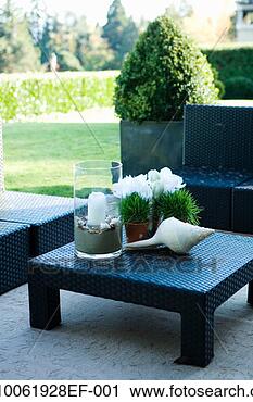 Stock Photography - candle, plant 
and ornaments 
on garden table. 
fotosearch - search 
stock photos, 
pictures, images, 
and photo clipart