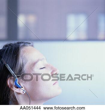 Stock Photo - woman with eyes 
closed listening 
to music with 
headphones. fotosearch 
- search stock 
photos, pictures, 
images, and photo 
clipart