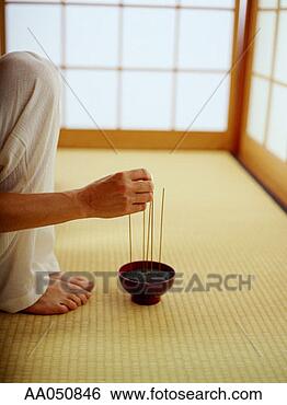 Stock Photo - woman kneeling 
to light incense. 
fotosearch - search 
stock photos, 
pictures, images, 
and photo clipart
