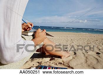 Stock Photography - young woman sitting 
on beach, sketching 
in journal. fotosearch 
- search stock 
photos, pictures, 
images, and photo 
clipart