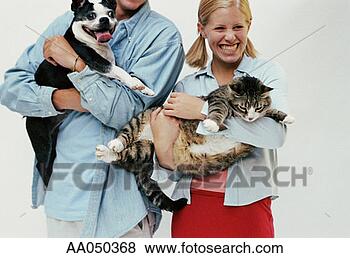 Stock Photo - teen boy holding 
his boston terrier, 
teen girl holding 
her cat. fotosearch 
- search stock 
photos, pictures, 
images, and photo 
clipart