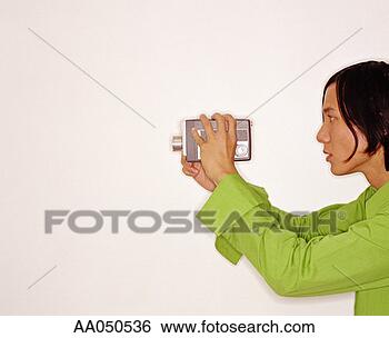 Stock Photo - young man using 
video camera. 
fotosearch - search 
stock photos, 
pictures, images, 
and photo clipart