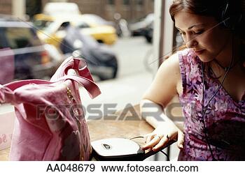 Stock Photograph - young woman listening 
to personal cd 
player. fotosearch 
- search stock 
photos, pictures, 
images, and photo 
clipart