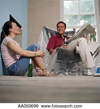 Stock Photograph - couple relaxing 
in new home. fotosearch 
- search stock 
photos, pictures, 
images, and photo 
clipart