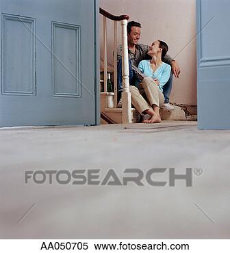 Stock Image - couple relaxing 
on stairs of new 
home. fotosearch 
- search stock 
photos, pictures, 
images, and photo 
clipart