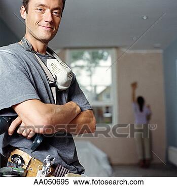 Stock Image - man wearing tool 
belt in house. 
fotosearch - search 
stock photos, 
pictures, images, 
and photo clipart