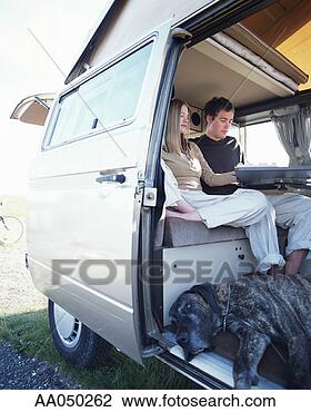 Stock Photo - young couple sitting 
in camper van 
with great dane. 
fotosearch - search 
stock photos, 
pictures, images, 
and photo clipart