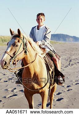 Stock Photography - boy (9-11) riding 
horse on beach, 
washington, usa 
(selective focus). 
fotosearch - search 
stock photos, 
pictures, images, 
and photo clipart