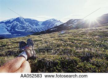 Stock Photo - hiker lying in 
meadow, ground 
view (focus on 
feet). fotosearch 
- search stock 
photos, pictures, 
images, and photo 
clipart