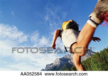 Stock Photo - man trail running, 
low angle view 
(blurred motion). 
fotosearch - search 
stock photos, 
pictures, images, 
and photo clipart