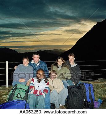Stock Photography - six young hikers 
sitting outdoors, 
smiling, portrait. 
fotosearch - search 
stock photos, 
pictures, images, 
and photo clipart