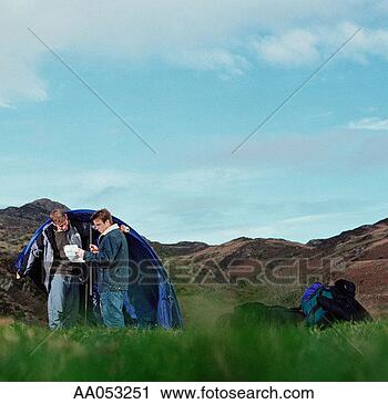 Stock Photography - two young men 
setting up tent, 
reading instructions. 
fotosearch - search 
stock photos, 
pictures, images, 
and photo clipart