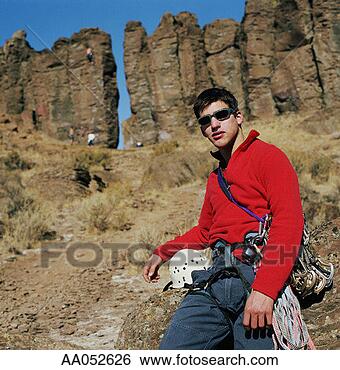 Stock Photo - young man carrying 
rock climbing 
equipment (selective 
focus). fotosearch 
- search stock 
photos, pictures, 
images, and photo 
clipart