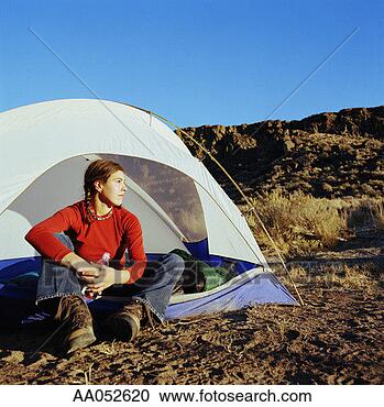 Stock Photography - young woman sitting 
in tent in desert, 
looking away, 
washington, usa. 
fotosearch - search 
stock photos, 
pictures, images, 
and photo clipart