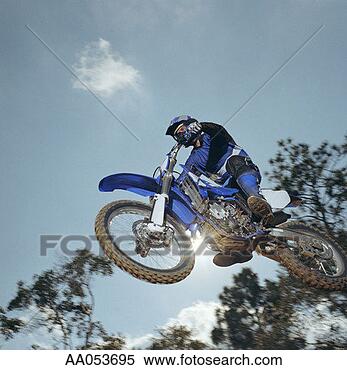 Stock Image - motocross rider 
in mid-air, low 
angle view. fotosearch 
- search stock 
photos, pictures, 
images, and photo 
clipart